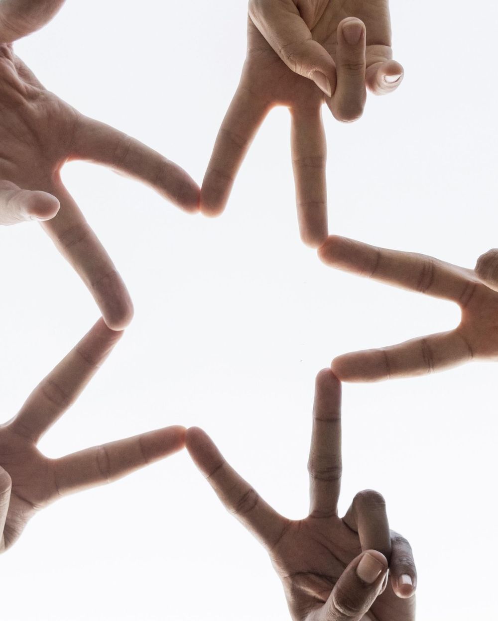 Hands joined together to form a star